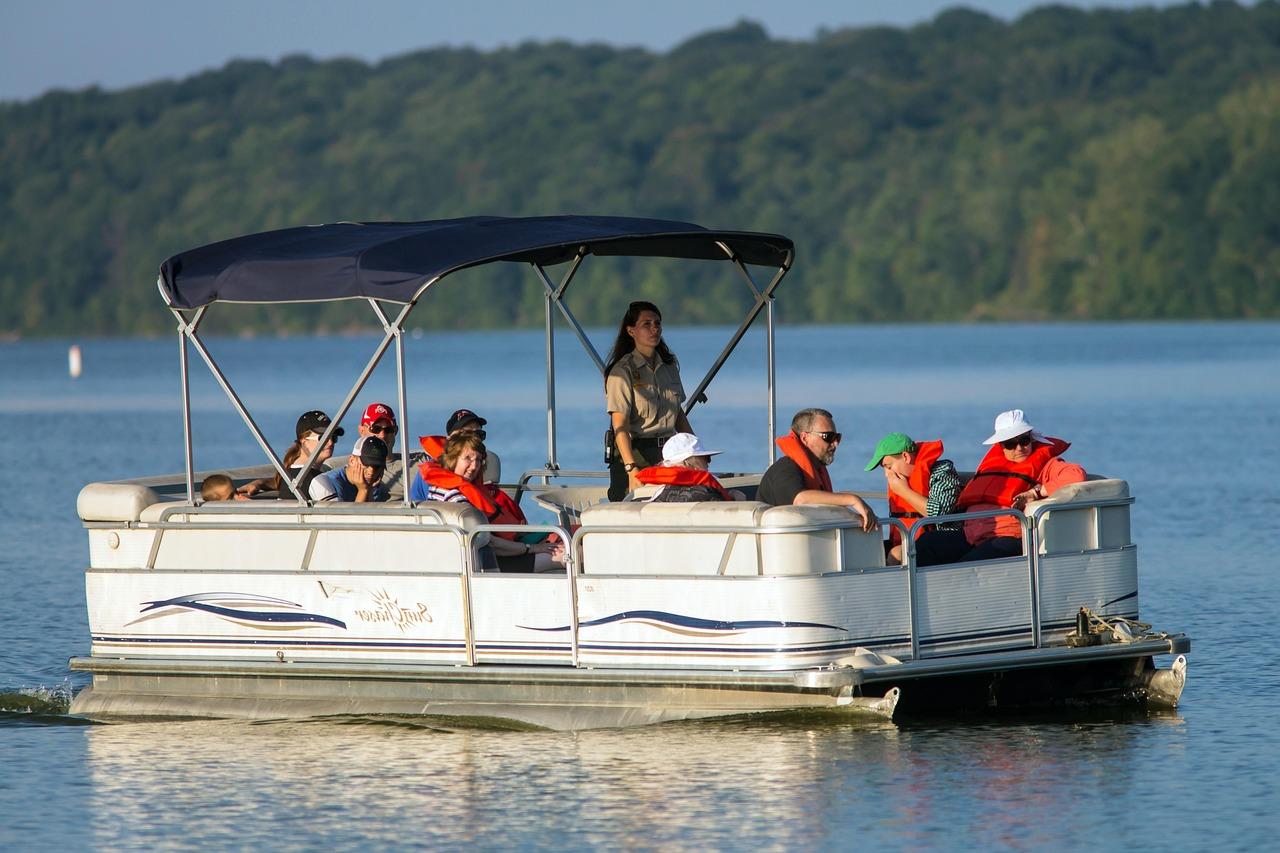 Group of people aboard a pontoon with life jackets